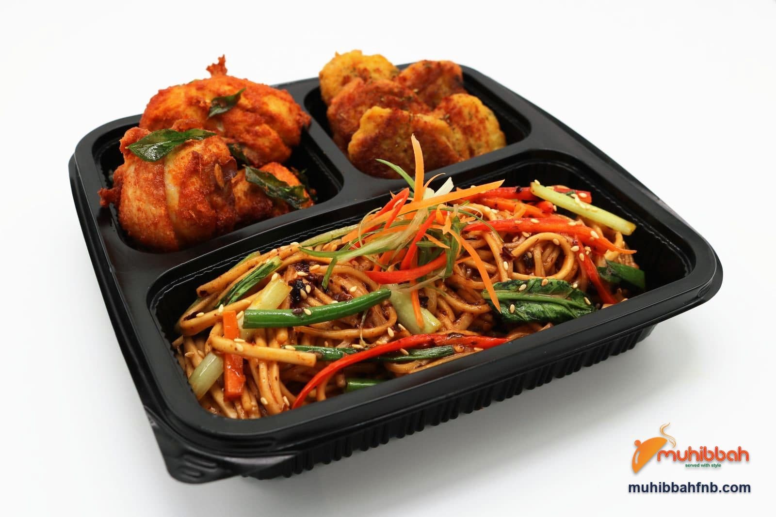 Bento box with chilli oil noodles and stir-fried vegetables