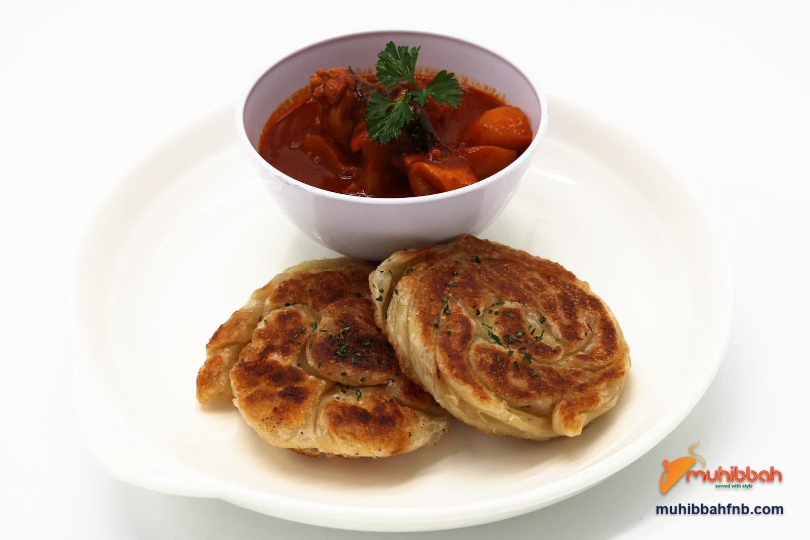 Roti bom served with a bowl of chicken curry