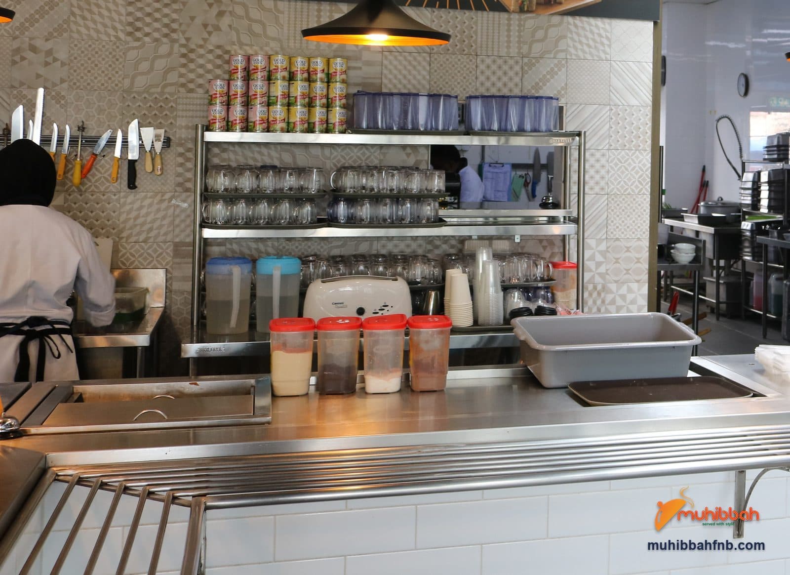 Service counter with glassware, condiments and prepared trays at a staff cafeteria