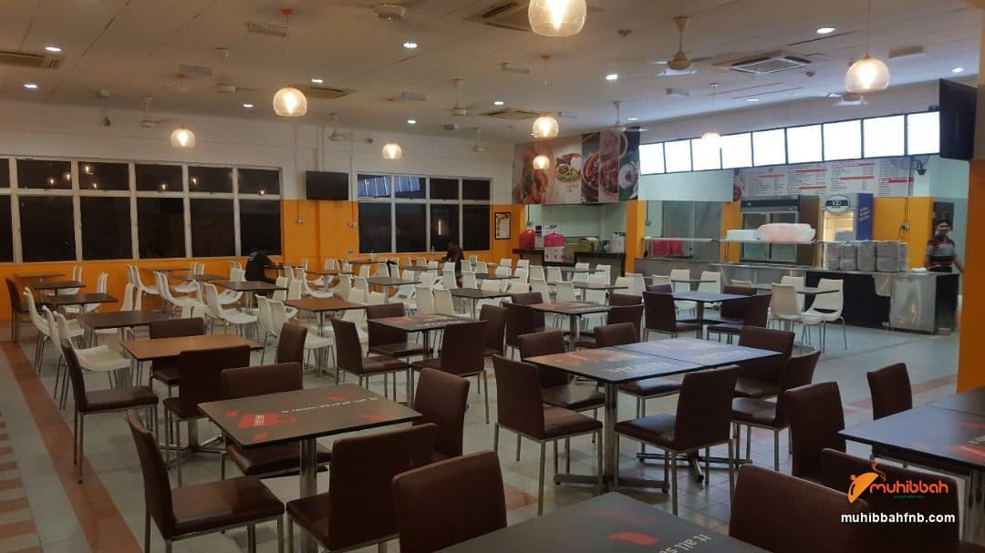 Dining hall seating with the serving counter in the background