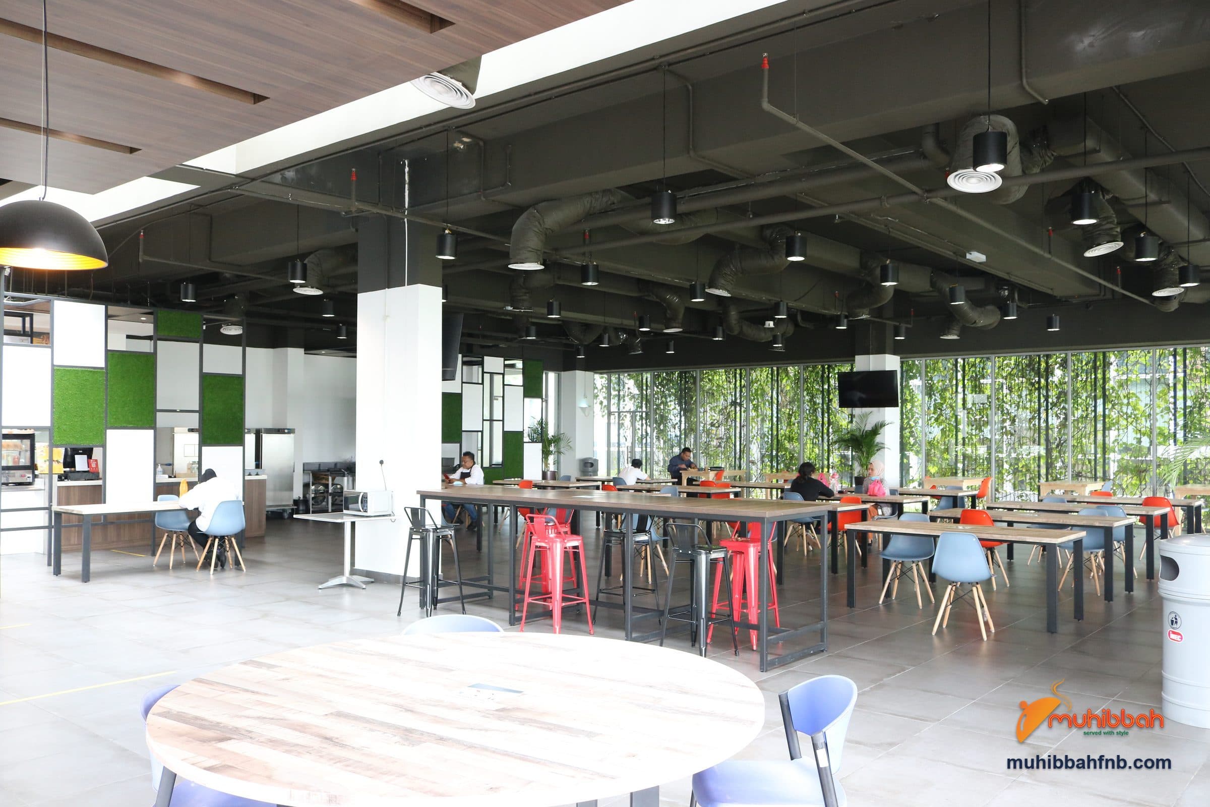 Corporate staff cafeteria dining hall with mixed seating and floor-to-ceiling windows