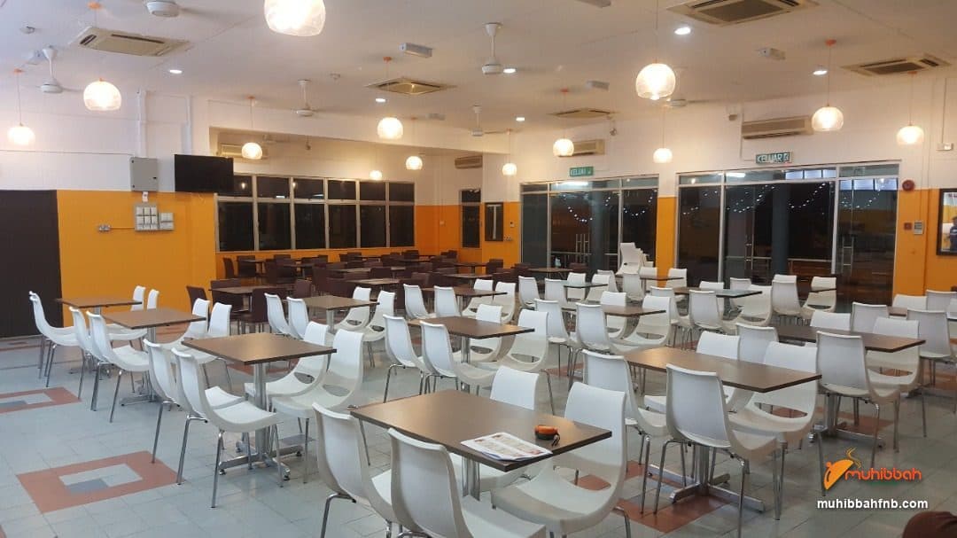 Staff dining hall set with tables and chairs before a meal service